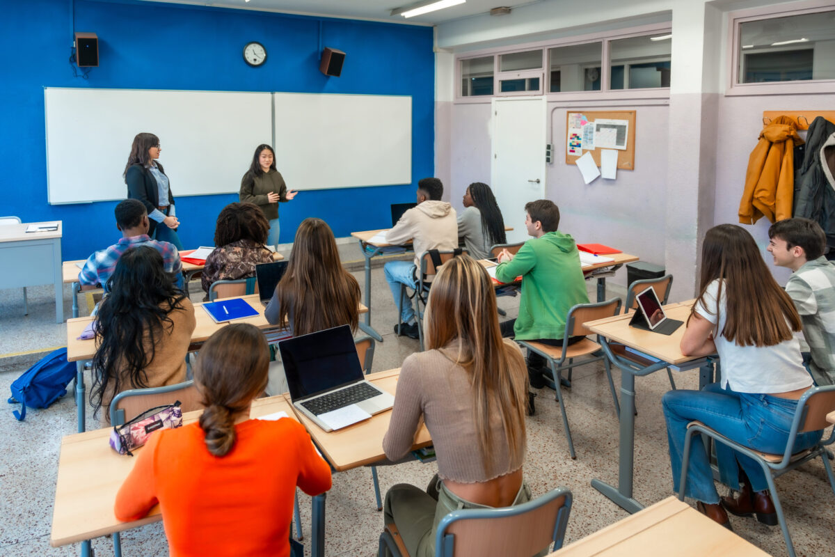 High school students attending a lecture in classroom at university institute